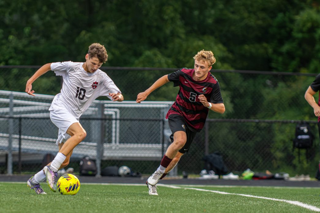 Tristan Lee of Saint Michaels and Caden Phillips of Snow Hill battle it out in varsity soccer game.