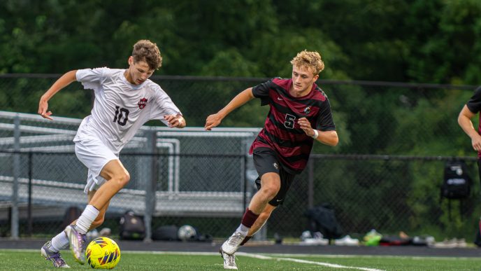 Tristan Lee of Saint Michaels and Caden Phillips of Snow Hill battle it out in varsity soccer game.