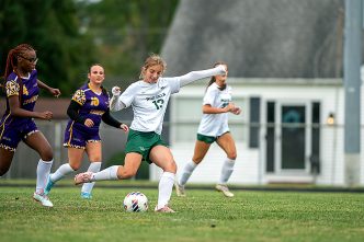 Grace Premo (13) of Mardela High School kicking a soccer ball.